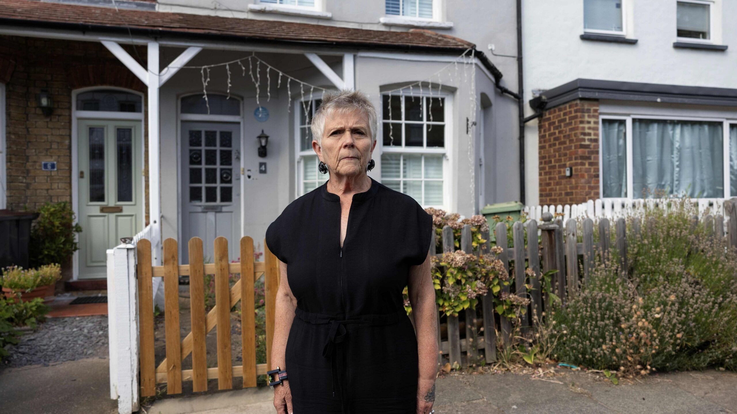 Ruth Dickie standing outside her home next to David Bowie's former house