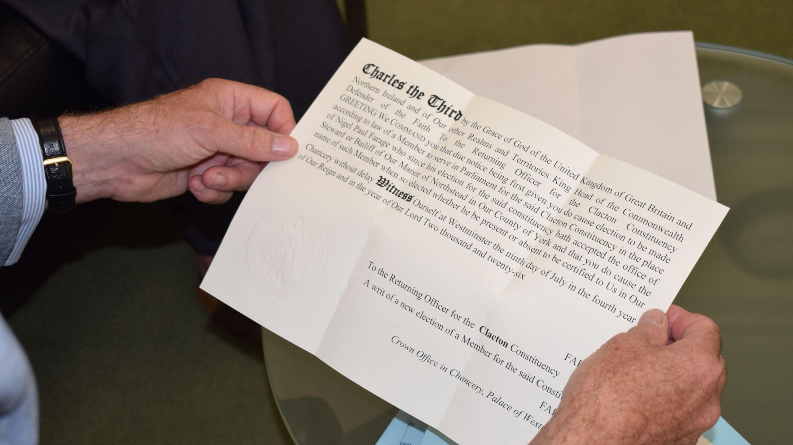 A piece of paper with the writ calling for a by election in the hands of the returning officer