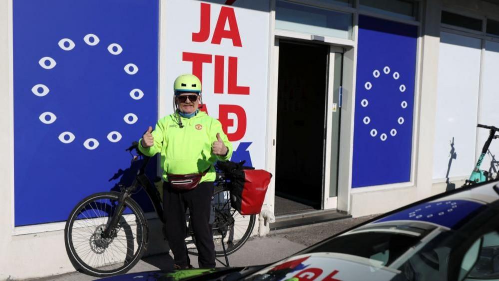 A man poses outside the "Yes to See" movement's office ahead of a referendum on whether Iceland should resume accession negotiations with the European Union, in Reykjavik, Iceland, August 2