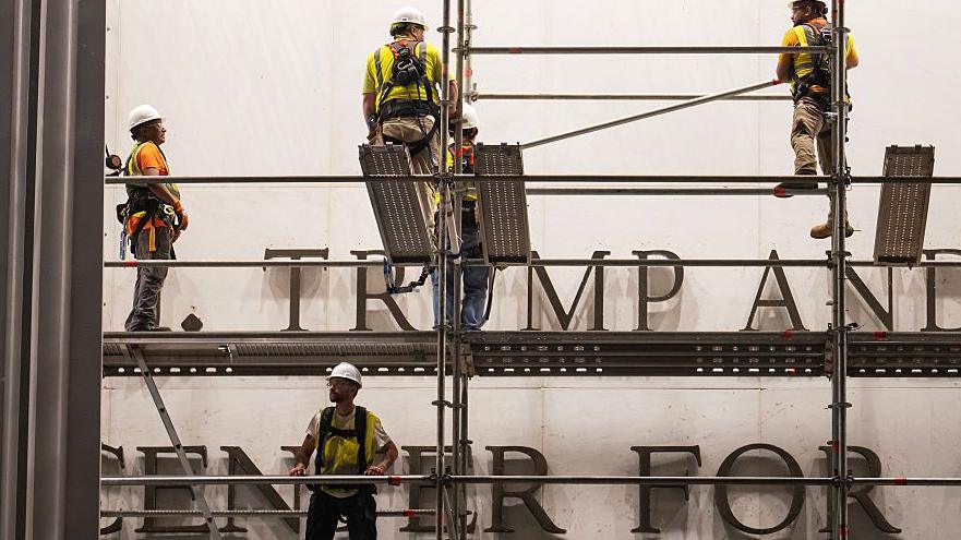 Workers put up scaffolding prior to the removal of President Donald Trump's name from the Kennedy Center on June 12, 2026 in Washington, DC.
