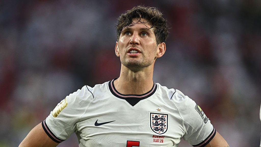 John Stones wearing an England shirt