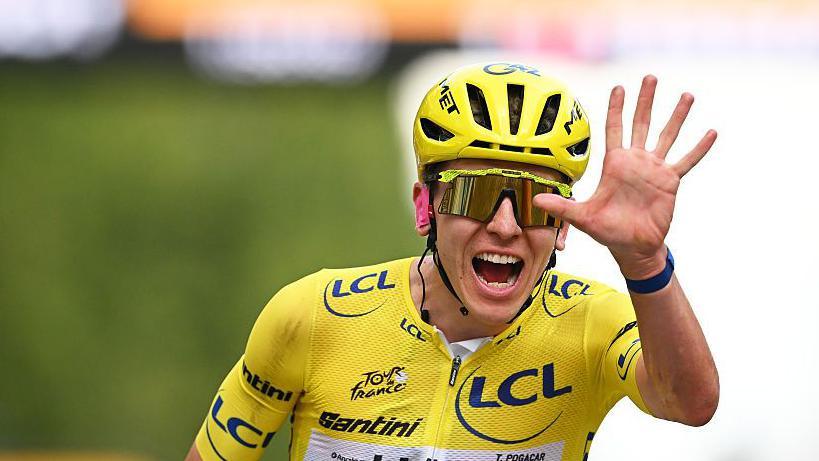 Tadej Pogacar celebrates winning the Tour de France