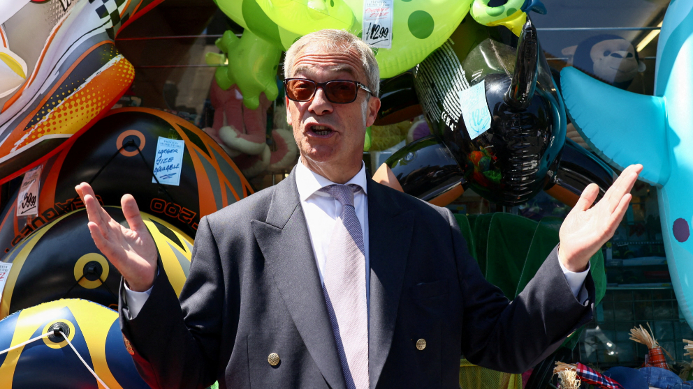 Leader of the Reform UK party Nigel Farage gestures next to a shop in Clacton, after he announced on Tuesday he would resign as an MP