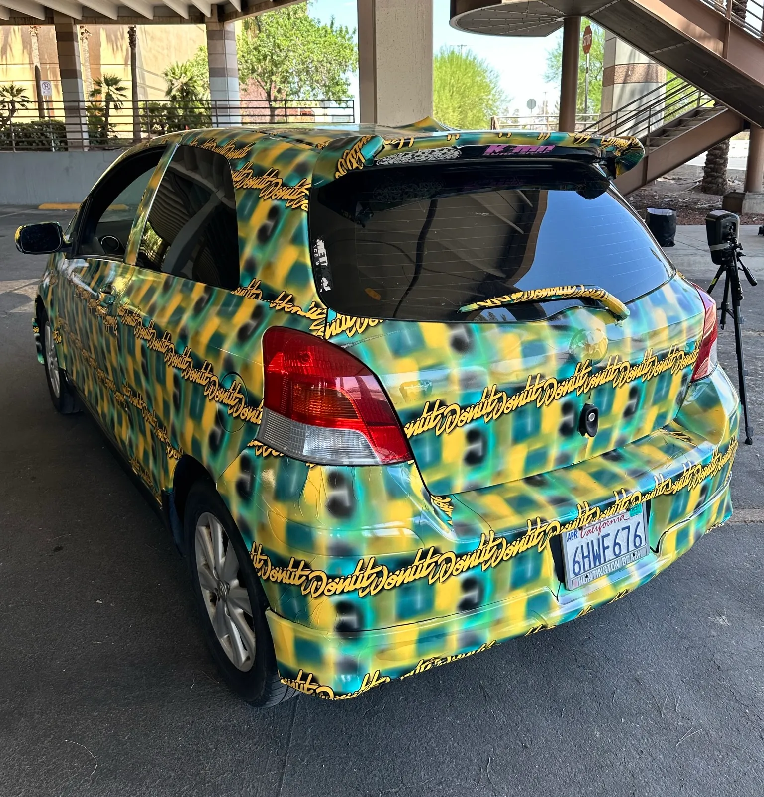 a photo of the toyota yaris covered in a pattern made by Bill Swearingen, as part of a test to see if it can defeat surveillance camera detection.