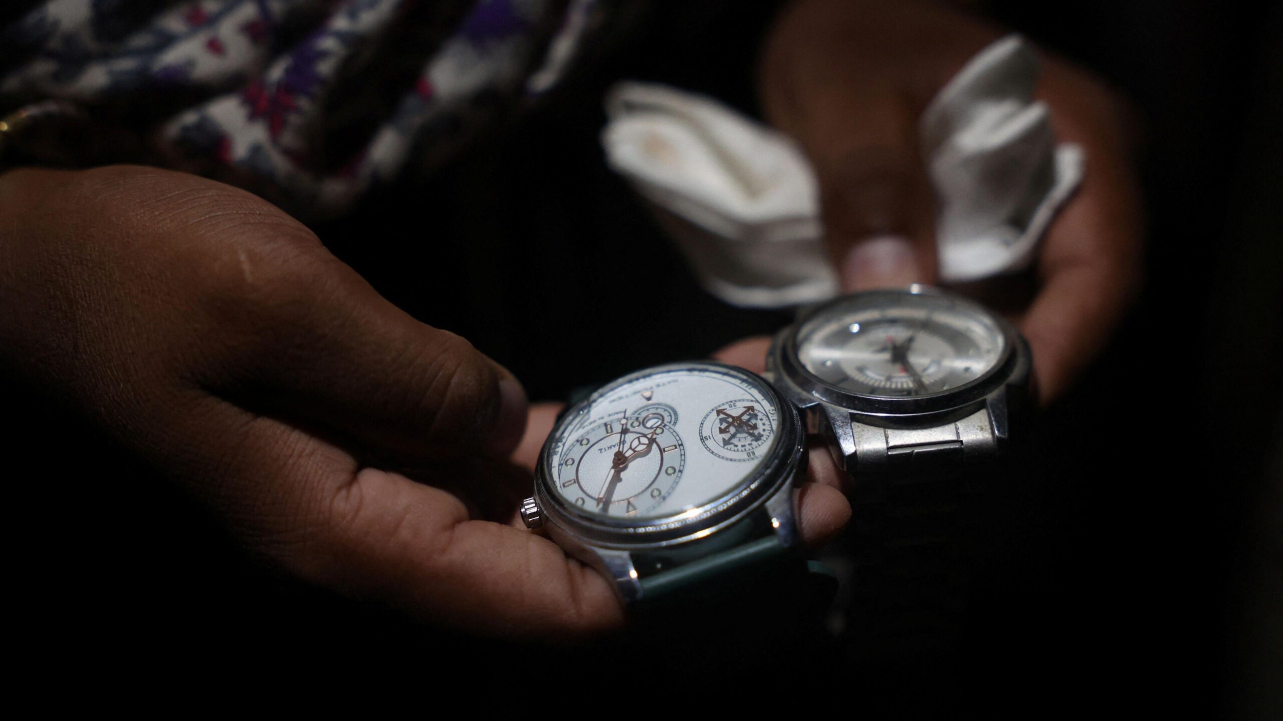 Babita Kumari, sister of Pradeep Kumar, 22, an aspirant doctor who took his own life after the results of the first NEET exam were cancelled, shows watches that Pradeep loved to wear, at her home in Jhunjhunu, India, July 21, 2026. REUTERS/Francis Mascarenhas