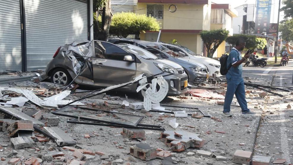 Vehicles damaged by a collapsed wall are seen following an earthquake in Cali, Colombia, 10 August 2026.