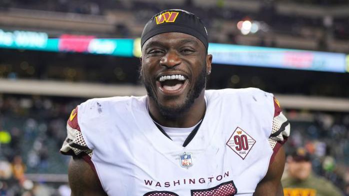 Efe Obada of the Washington Commanders smiles after an NFL game against the Philadelphia Eagles in November 2022
