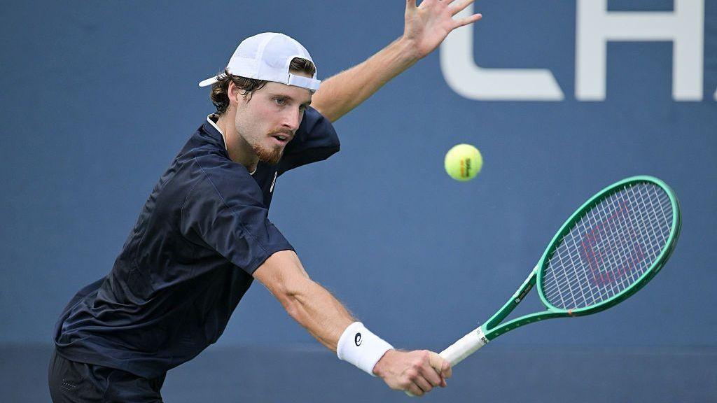 Toby Samuel hits a backhand during a men's qualifying singles match against Cristian Garin