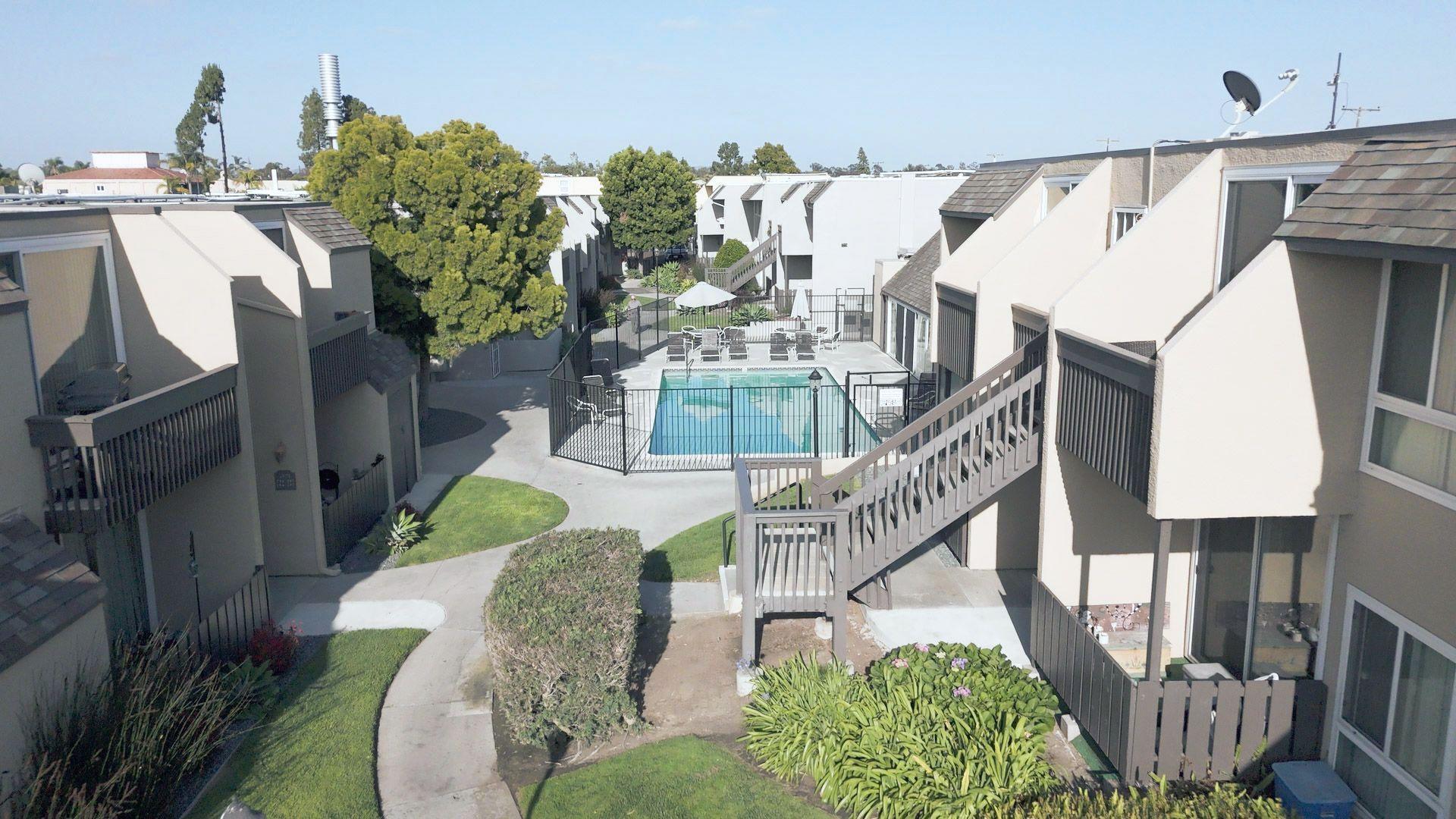 A view of the Parkview Apartments in Dan Diego. A swimming pool is seen in the middle of the complex.