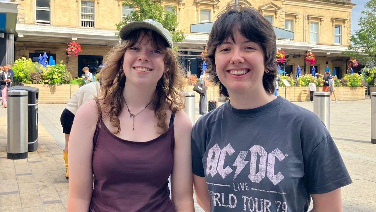 Sasha Baylors and Ciara Hornsey on their way to Reading Festival. Sasha wears a burgundy top and Ciara a grey AC/DC top.
