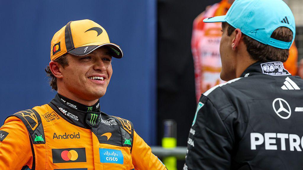 Lando Norris chats to George Russell after qualifying