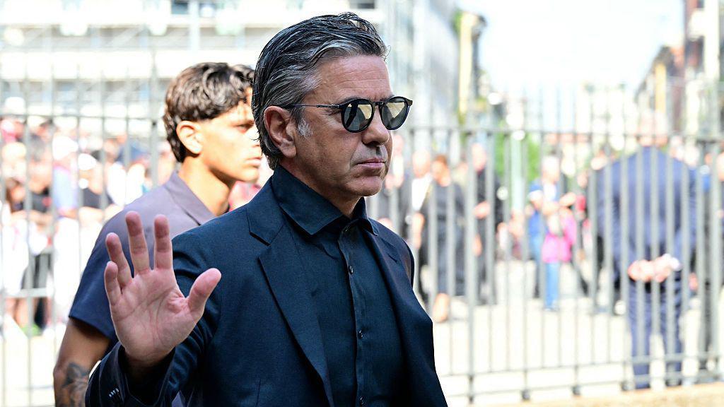 Alessandro Costacurta, wearing sunglasses, waves to the crowd at Franco Baresi's funeral