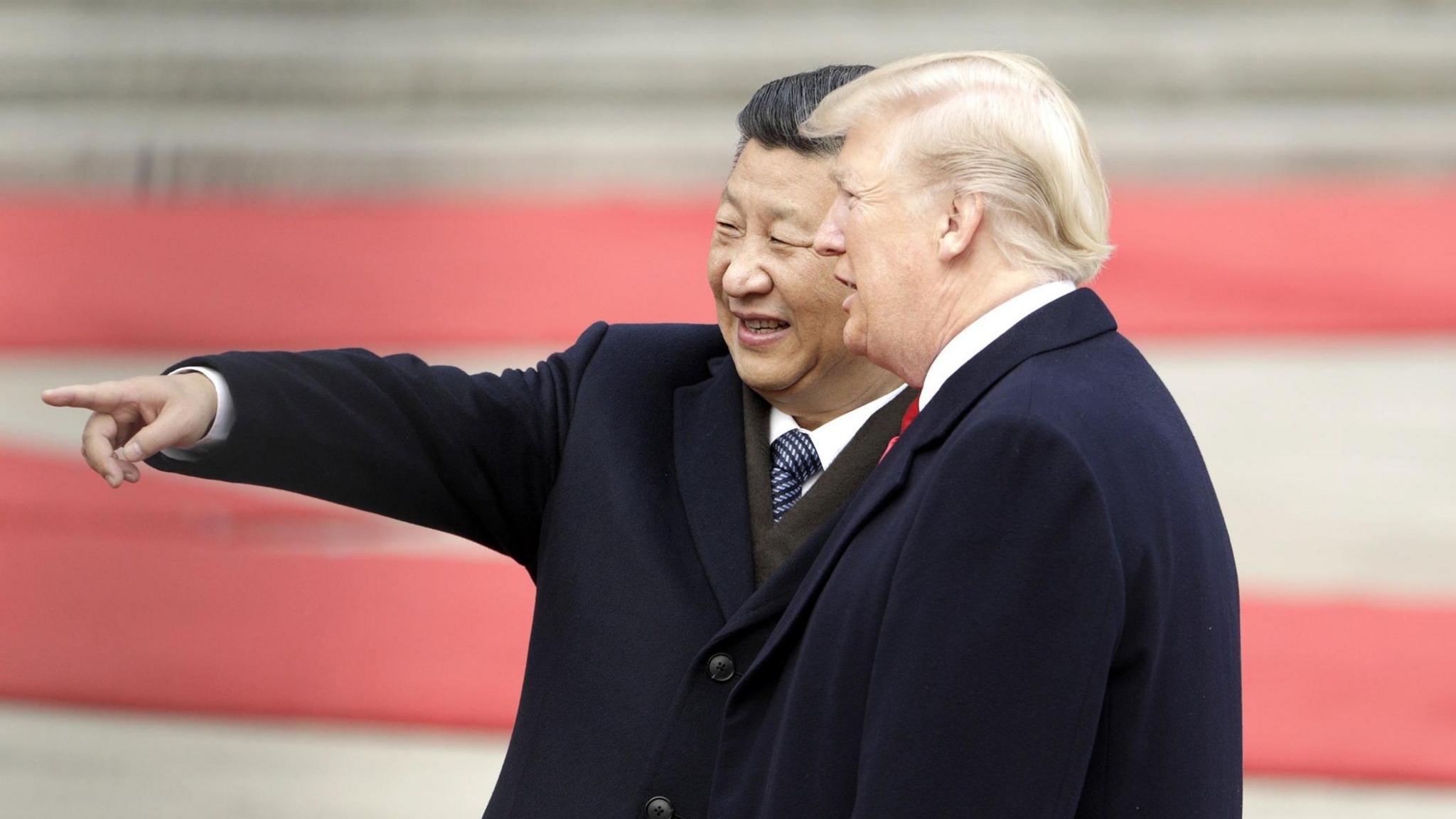 Xi Jinping, China's president, left, gestures while standing next to U.S. President Donald Trump, during a welcome ceremony outside the Great Hall of the People in Beijing, China, in November 2017.