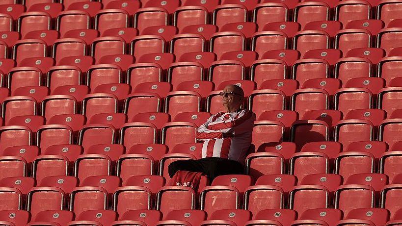 A lonely Stoke fan basks in the sunshine in the stands