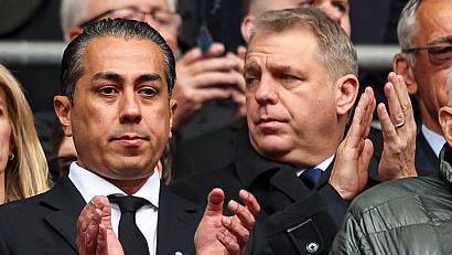 Eghbali claps as Boehly looks off to the side