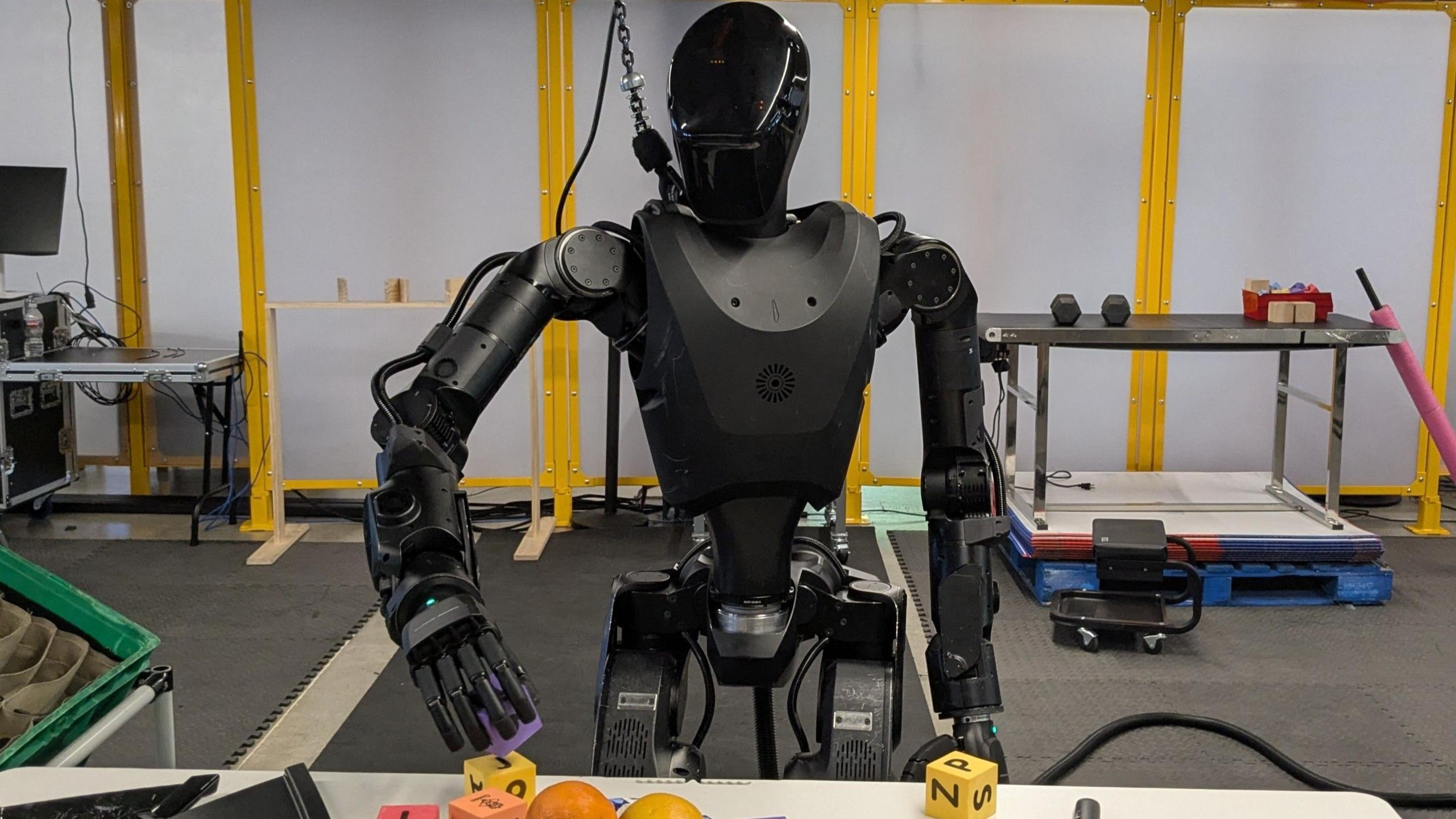 The all black Phantom robot handles building blocks.