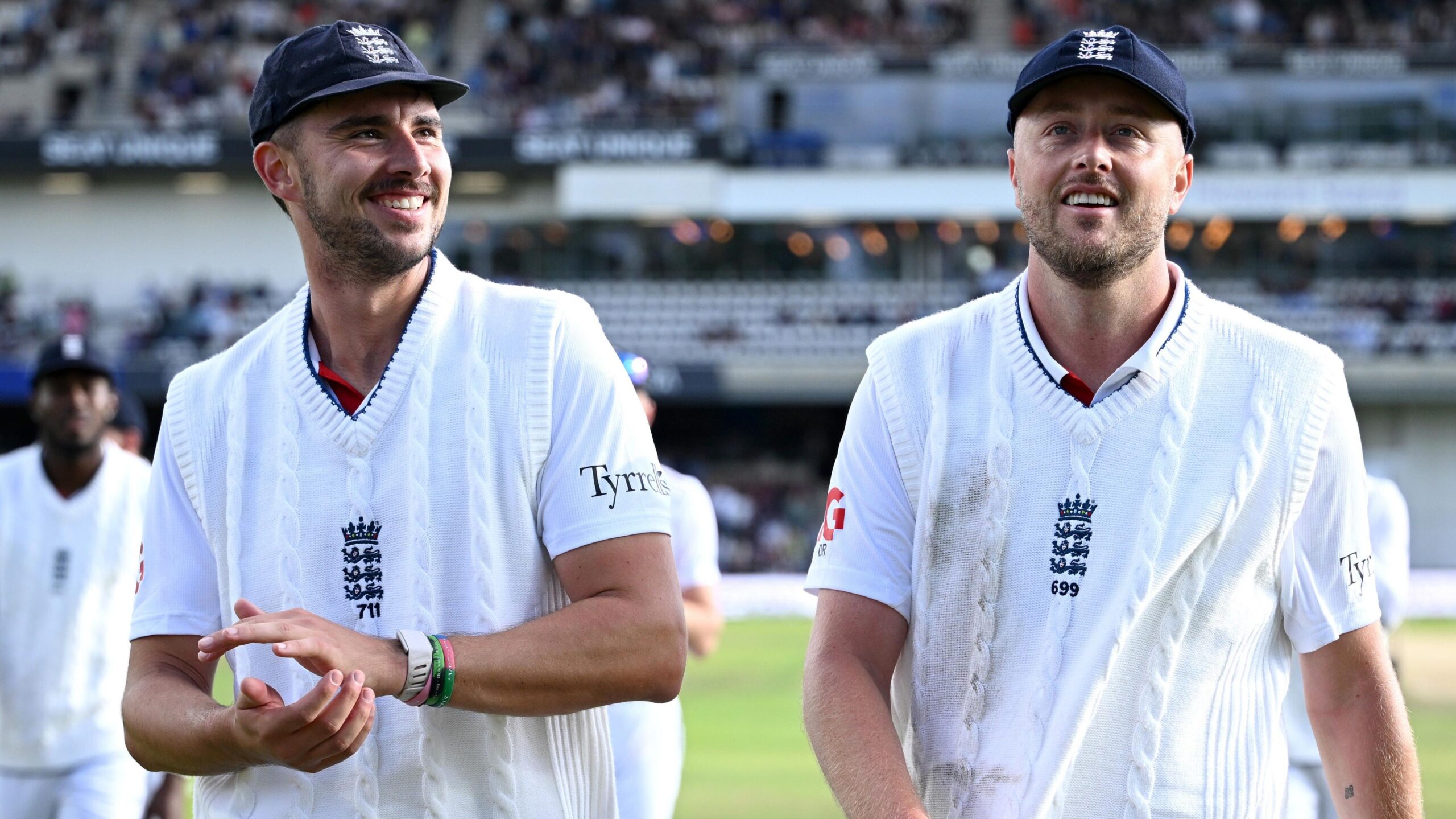 Josh Tongue and Ollie Robinson smile as they walk off the field together