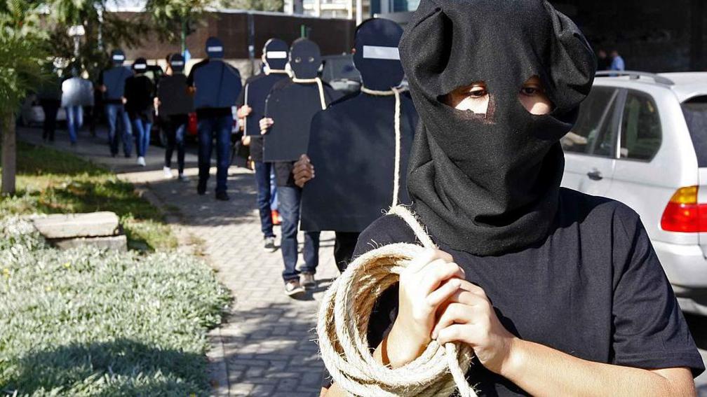 Protesters hold cardboard figures with ropes round their necks during a rally against the death penalty in Beirut, Lebanon. File photo from October 2013.