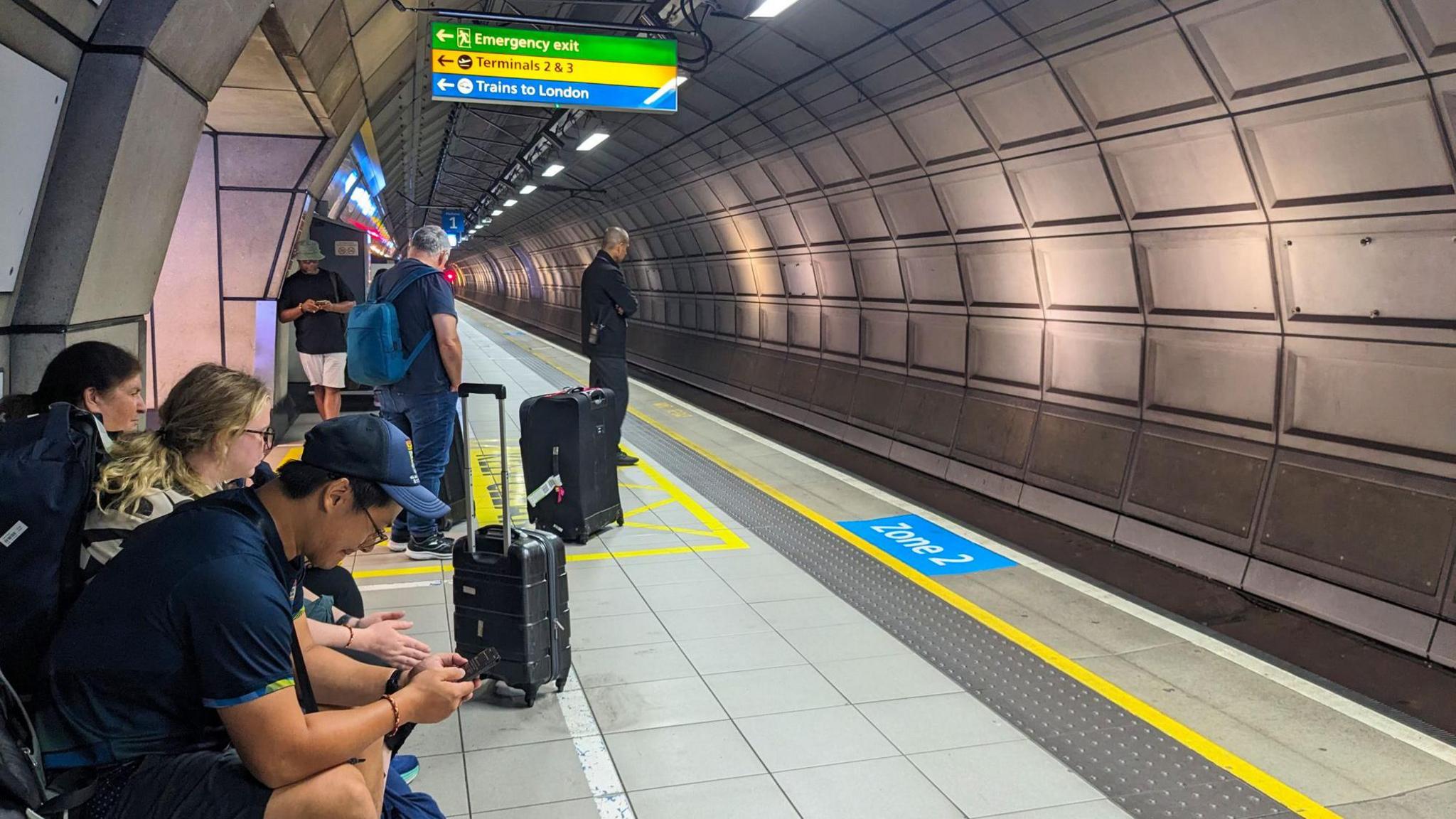 Stock photo of passengers waiting at one of Heathrow Airport's train stations