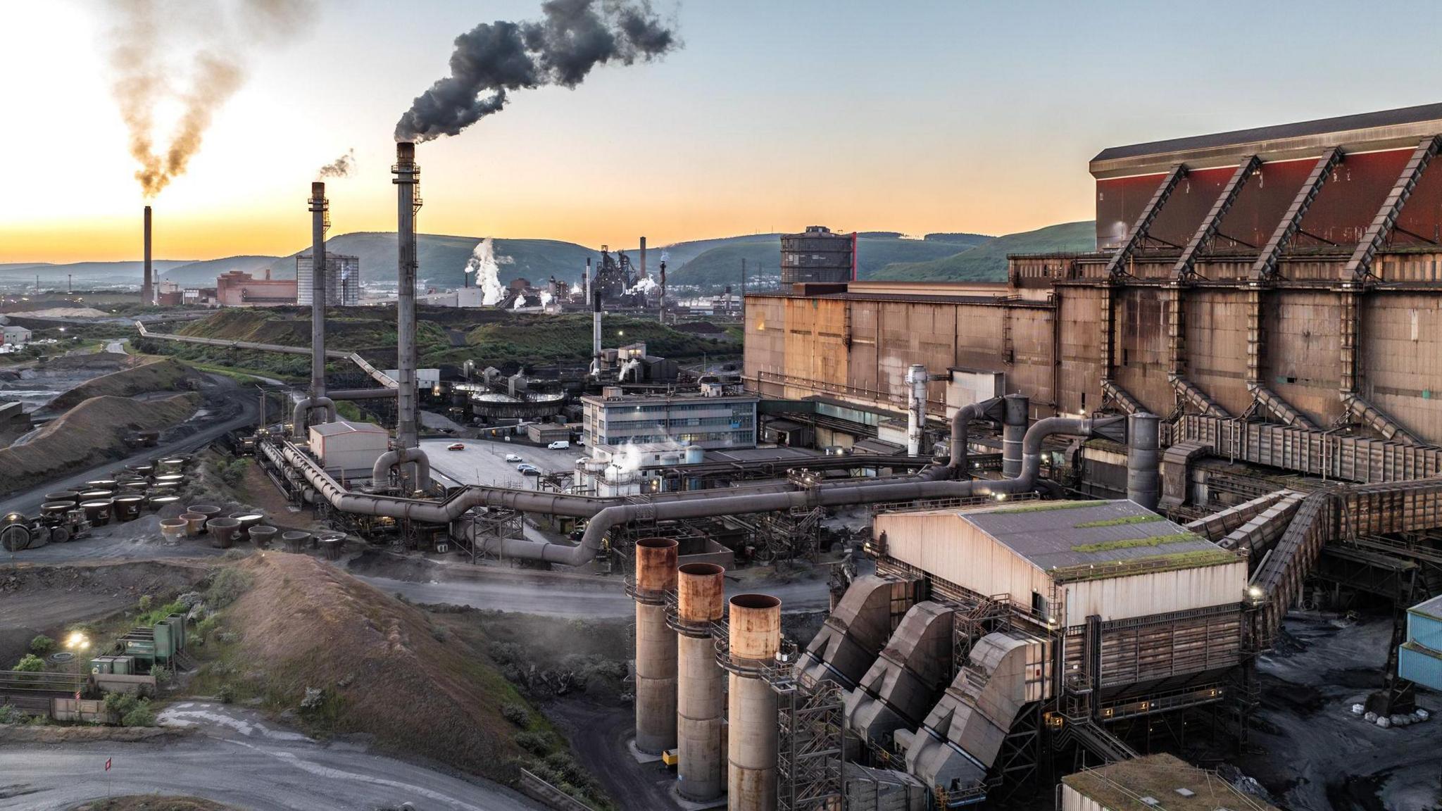 Aerial view of steel plant industry in Port Talbot with smoke rising into the sky
