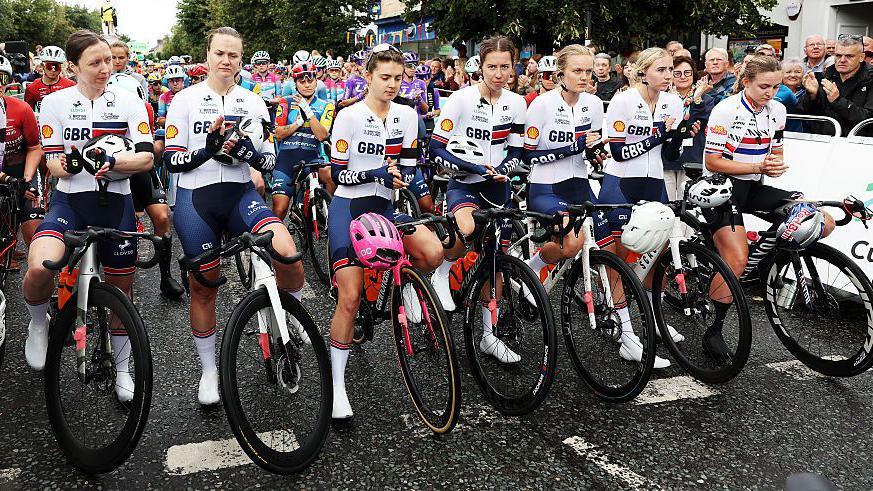 Rider's from the Great Britain Cycling Team at the start line of the Tour of Britain paying tribute to cyclist Fin Tarling with a minute's applause