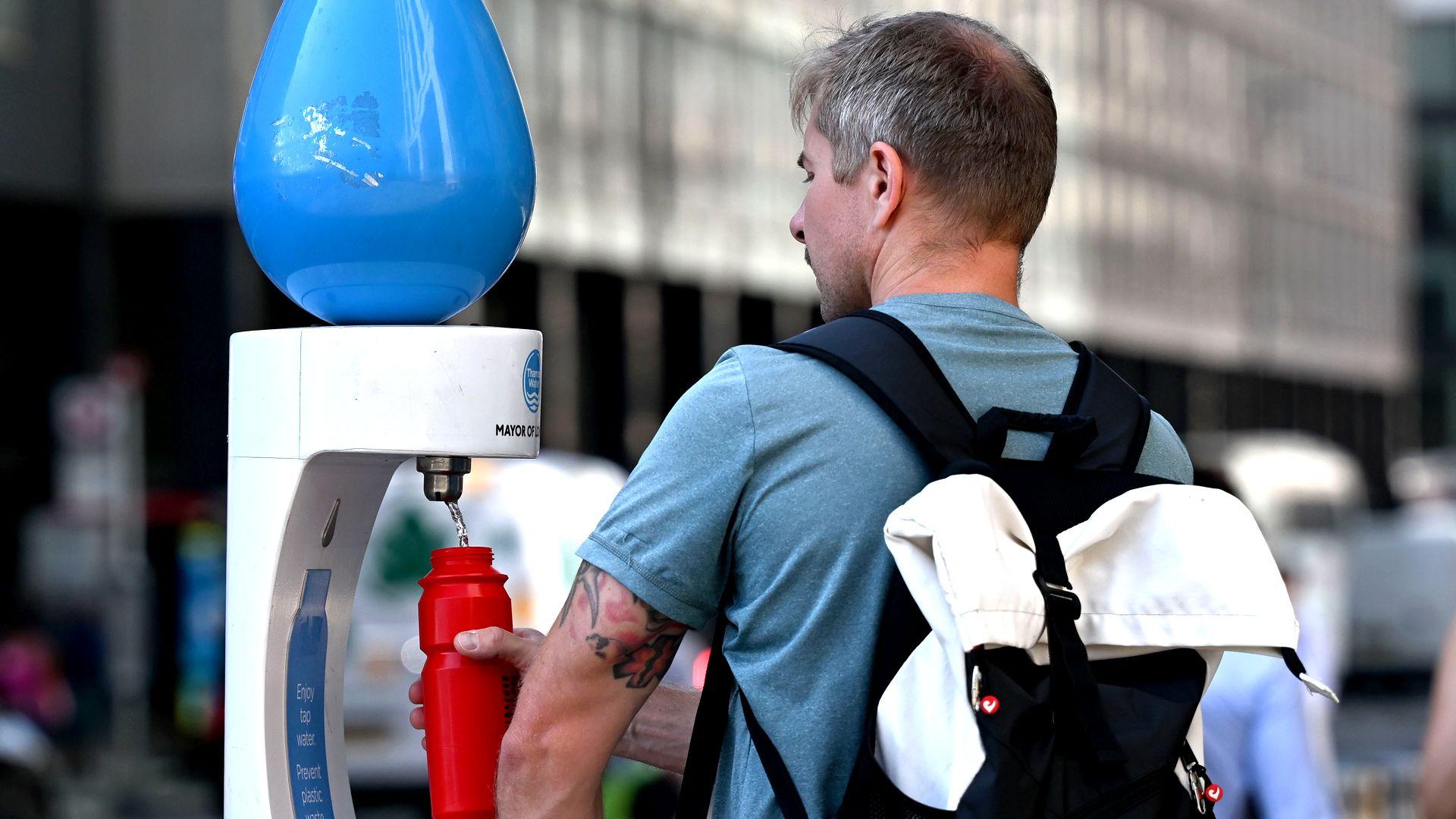 A man filling up his drink water to cool off as London experiences warm weather during a heatwave in London, United Kingdom, on July 29, 2026