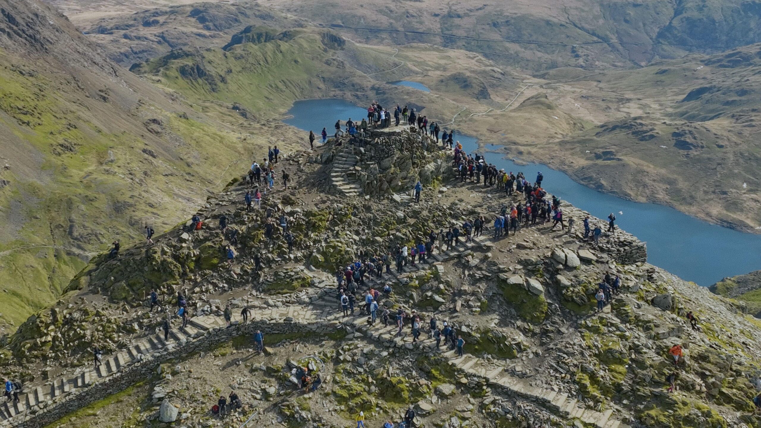 Hikers queuing on the summit of Yr Wyddfa