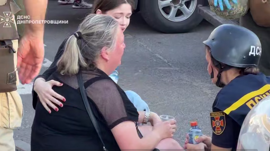 A psychologist talks to a distressed woman after a Russian drone attack in Kryvyi Rih, central Ukraine. Screenshot from a video by Ukraine's state emergencies service DSNS