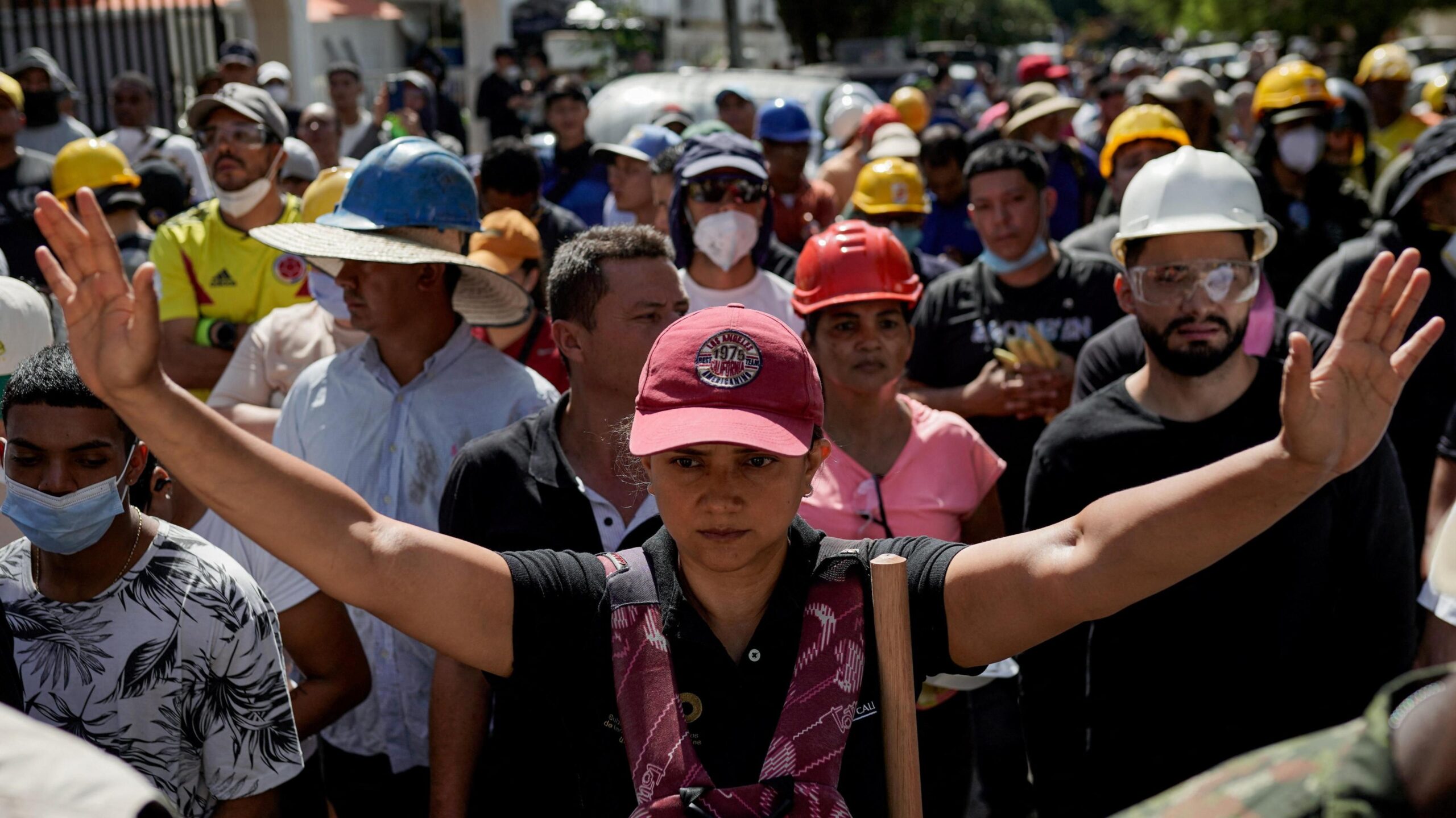 A woman gestures as people search for survivors at the site of a collapsed building, in the aftermath of an earthquake, in Cali, Colombia, August 11, 2026.