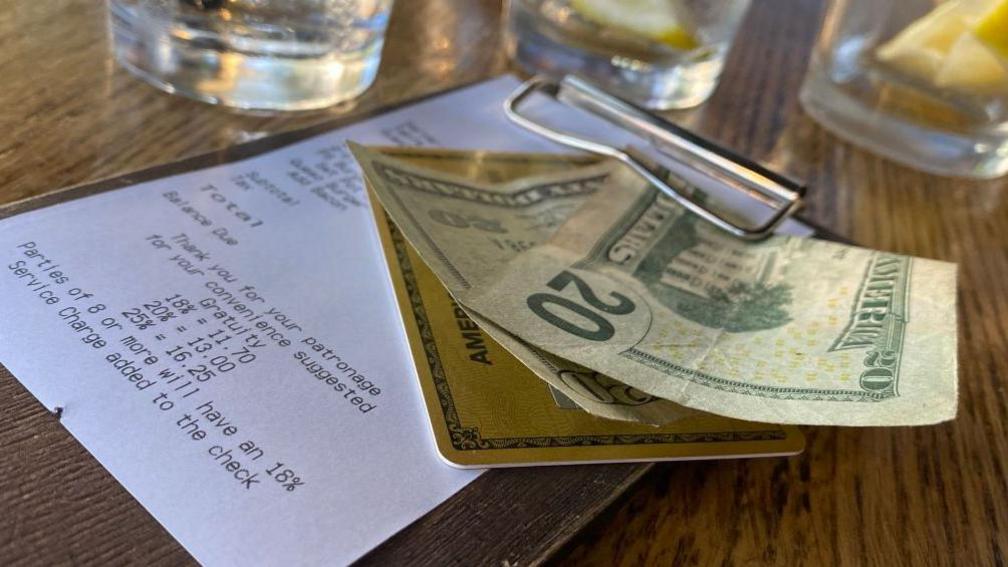 A $20 dollar cash tip left on the bill at a US restaurant