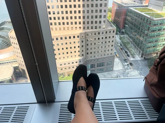Image may contain: City, Urban, Clothing, Footwear, Shoe, Sandal, Architecture, Building, Condo, Housing, and High Rise