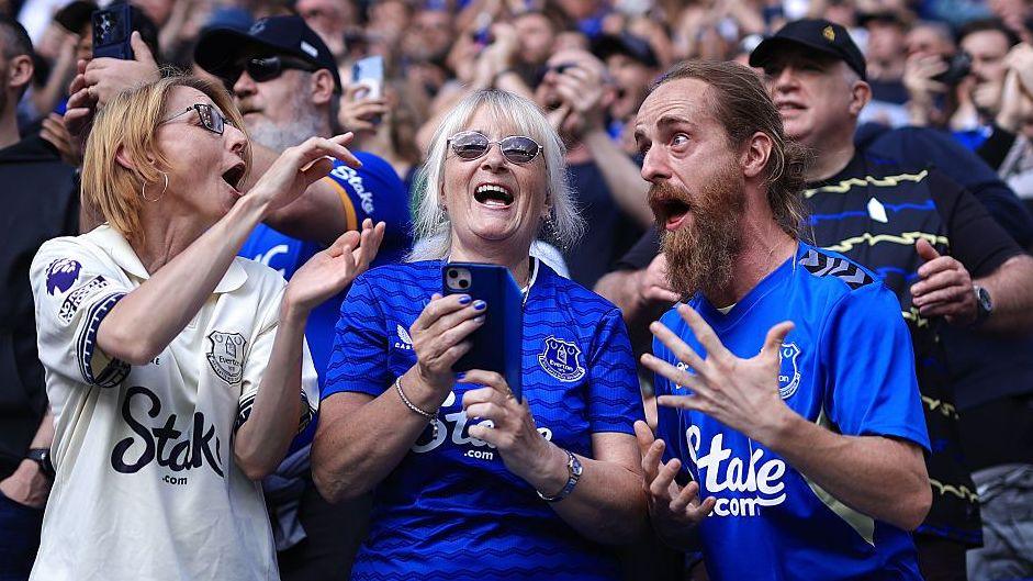 Three Everton fans enjoying a match