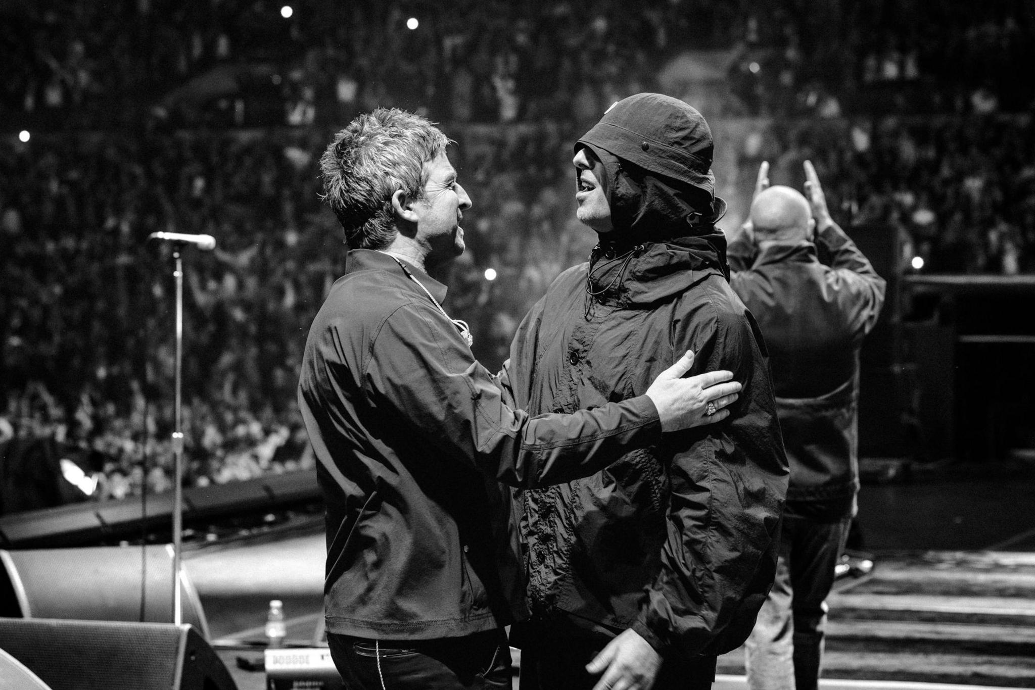 Liam and Noel (left) Gallagher enjoy a moment on stage together during their best-selling reunion tour