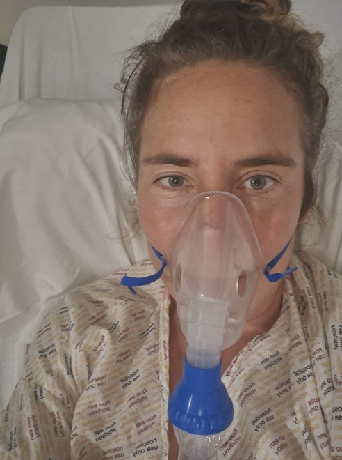 Jackie Bachteler in hospital with an oxygen mask covering her mouth and nose