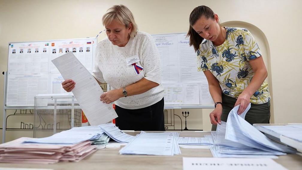Members of an electoral commission count votes after polls close on the final day of elections to Russia's ninth State Duma, the lower house of parliament