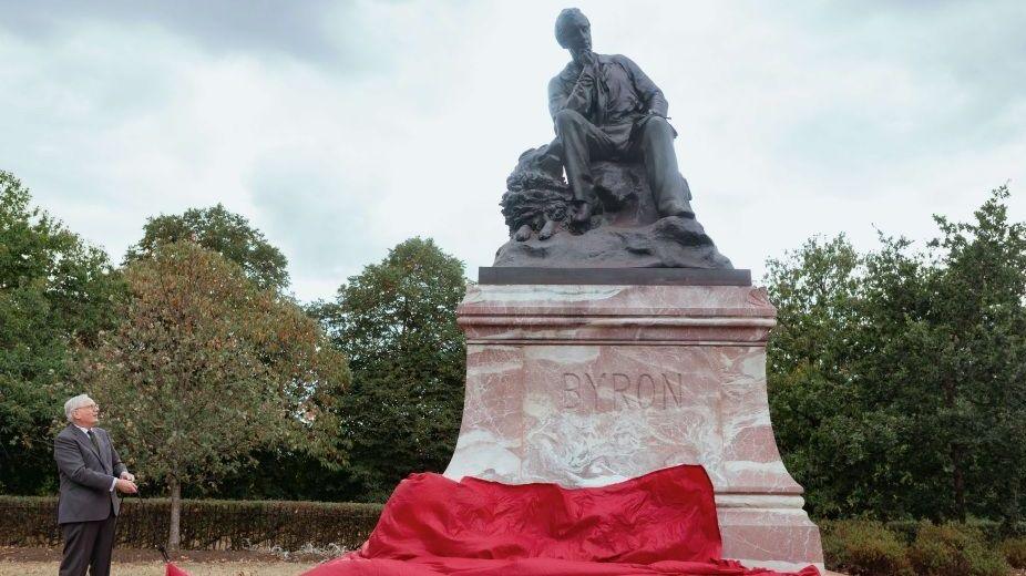 Statue of Byron with a red cloth being pulled off by the Duke
