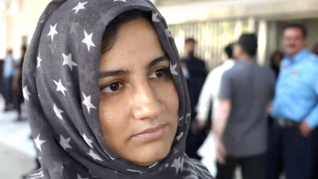 No fire alarms or sprinklers at Pakistan neonatal unit where fire killed 14, report finds Woman wearing headscarf with stars outside Islamabad's PIMS hospital