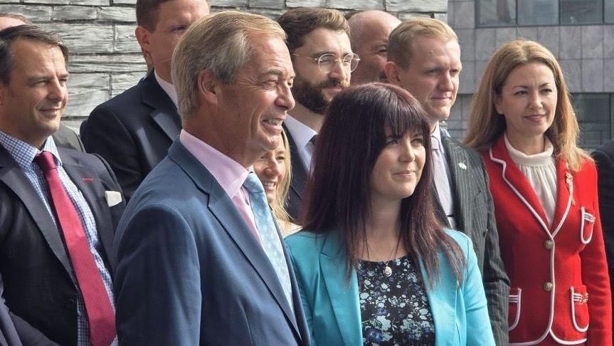 Nigel Farage and Helen Jenner with Reform members outside the Senedd