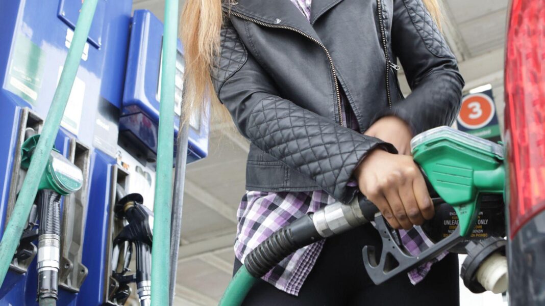 Oil, gas and borrowing costs surge as fears over Middle East escalate Person wearing a black leather jacket filling up their car from the petrol pump
