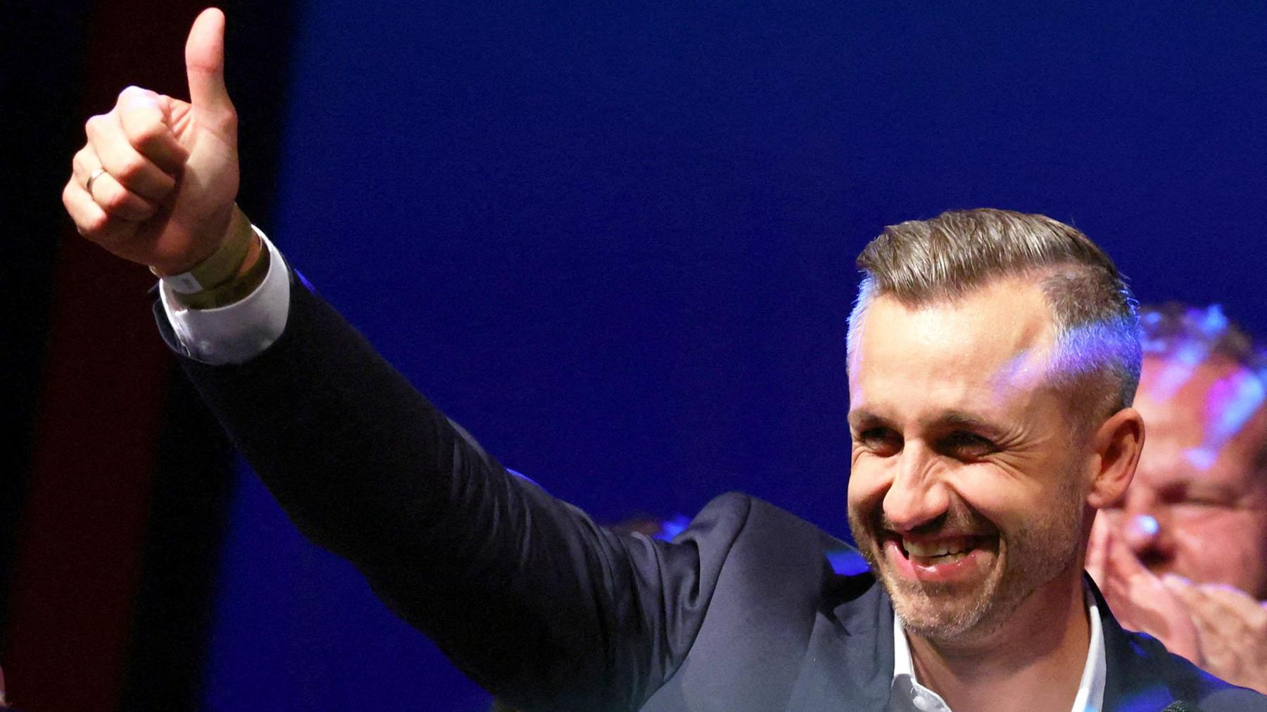 Ulrich Siegmund, leader of the AfD in the state, raises a thumbs up at the election party.