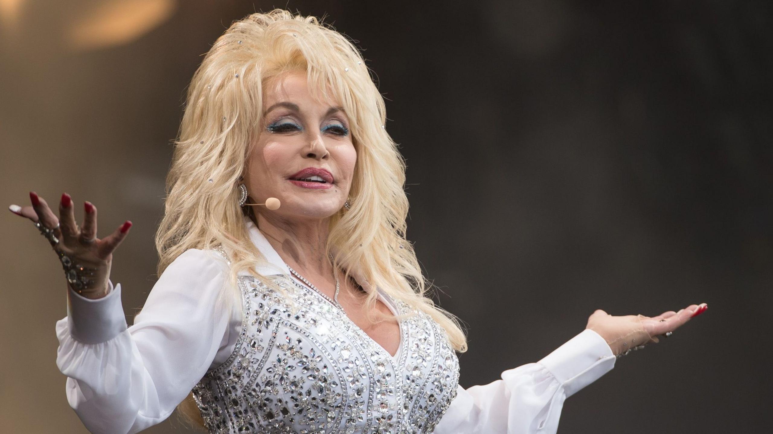 Dolly Parton in a white jewelled outfit