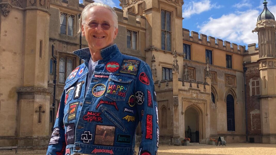 Freddie Mercury mural unveiled at Wembley Park A man with grey hair is stood outside Knebworth house wearing a blue denim jacket covered in band badges