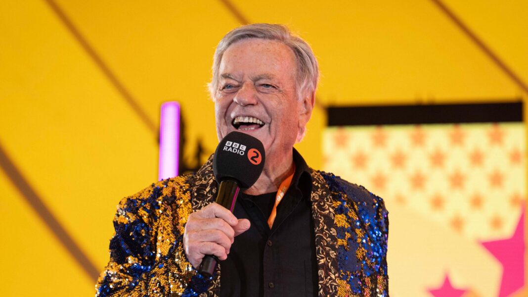 In pictures: Thousands flock to Radio 2 in the Park in Stirling Radio 2 DJ Tony Blackburn addresses the crowd on stage. He is smiling and wearing a gold and blue sparkly jacket