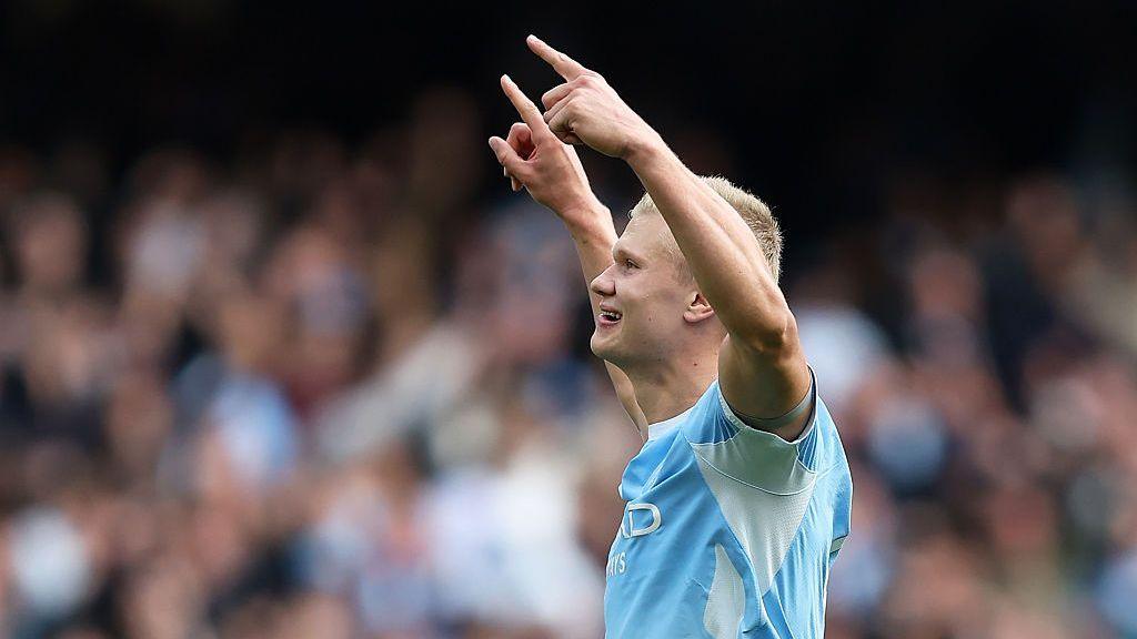 Erling Haaland celebrates scoring a Premier League goal for Manchester City by raising his arms aloft at the Etihad Stadium