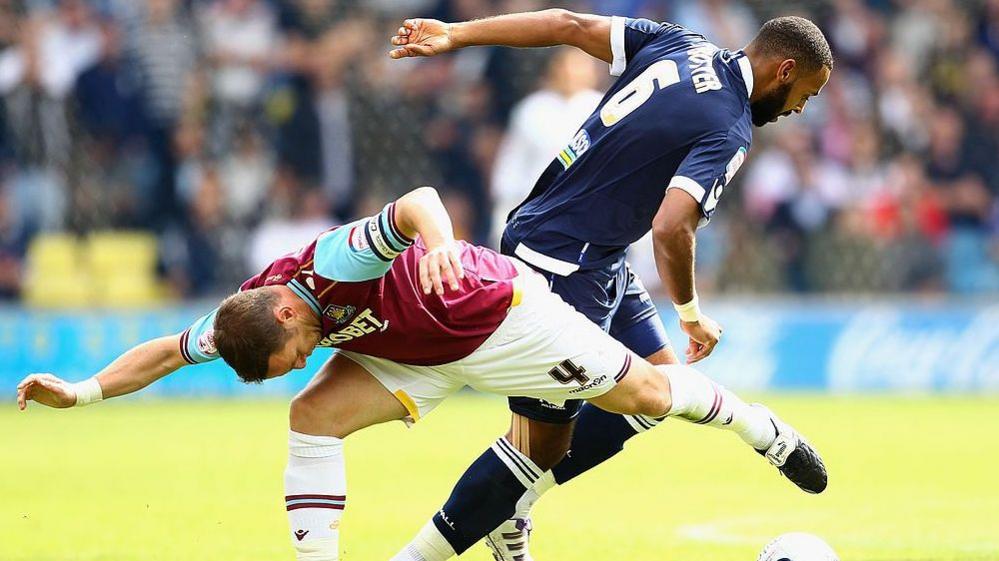 West Ham's Mark Noble and Liam Trotter of Millwall battle for the ball in the last meeting between the sides at The Den in 2011