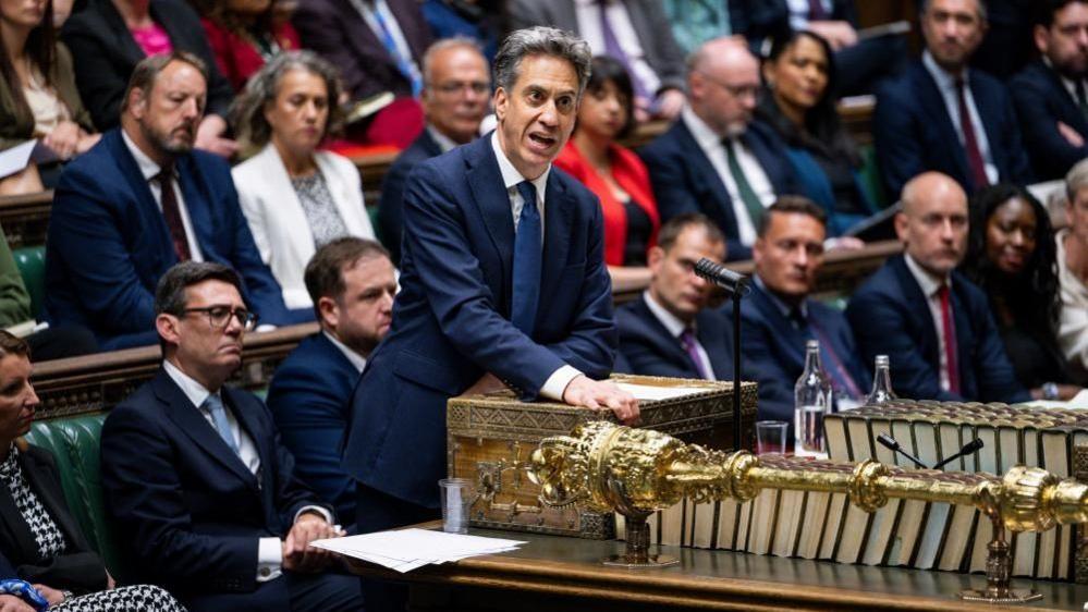 Andy Burnham seated behind Ed Miliband in the House of Commons