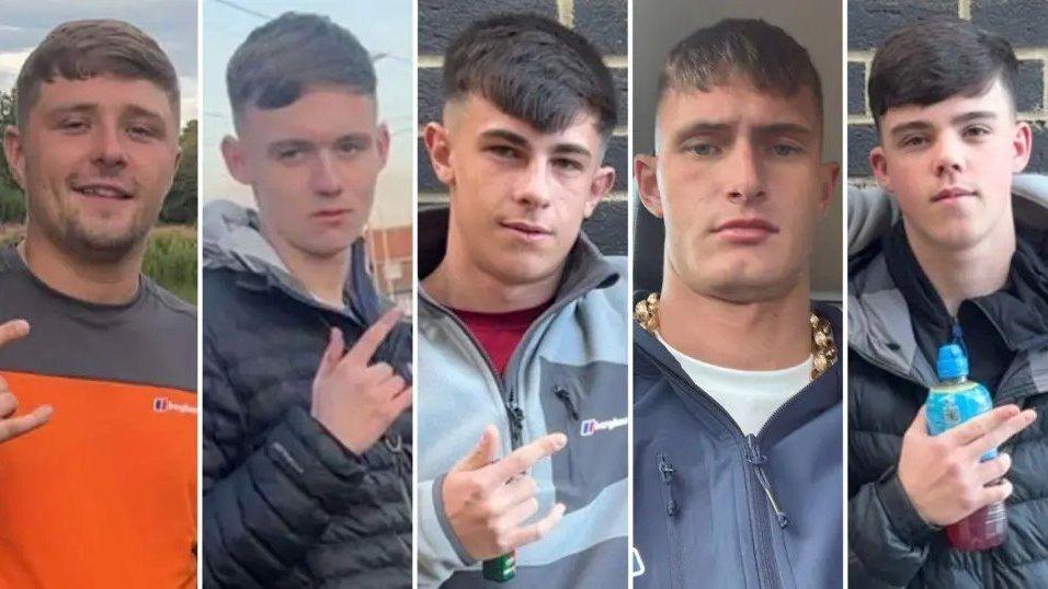 Five young men in their late teens and early 20s. They all have similar haircuts, with a fringe and faded back and sides. Four of them are gesturing with their fingers. Three of them extend their thumb, index, and pinky fingers - leaving their middle and ring finger tucked down. One points with his index and middle finger whilst holding a Lucozade bottle. They are all dressed in casual clothing.