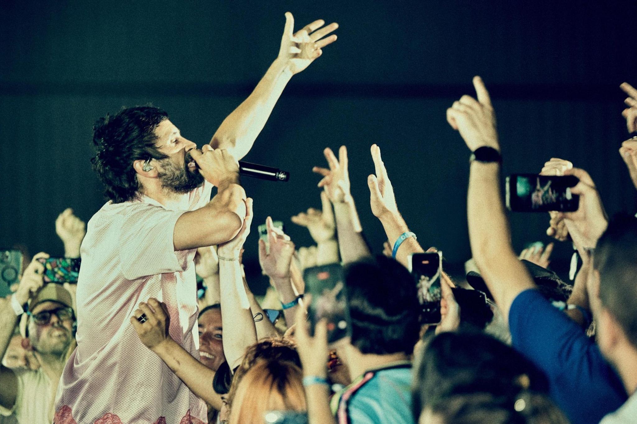 Serge Pizzorno stands in the middle of the audience as the band play a headline set at the Boardmasters festival