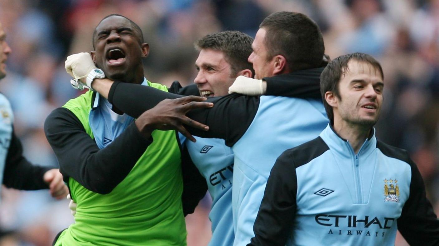 Micah Richards celebrates with members of the Manchester City staff after Sergio Aguero's goal against Queens Park Rangers in 2012