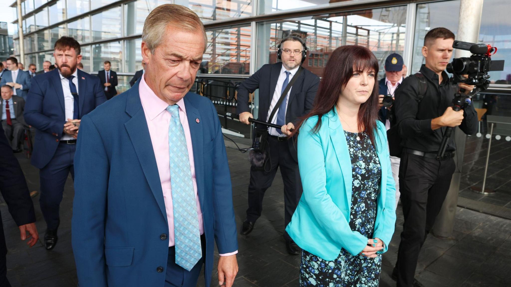 Nigel Farage and Helen Jenner walk outside the Senedd